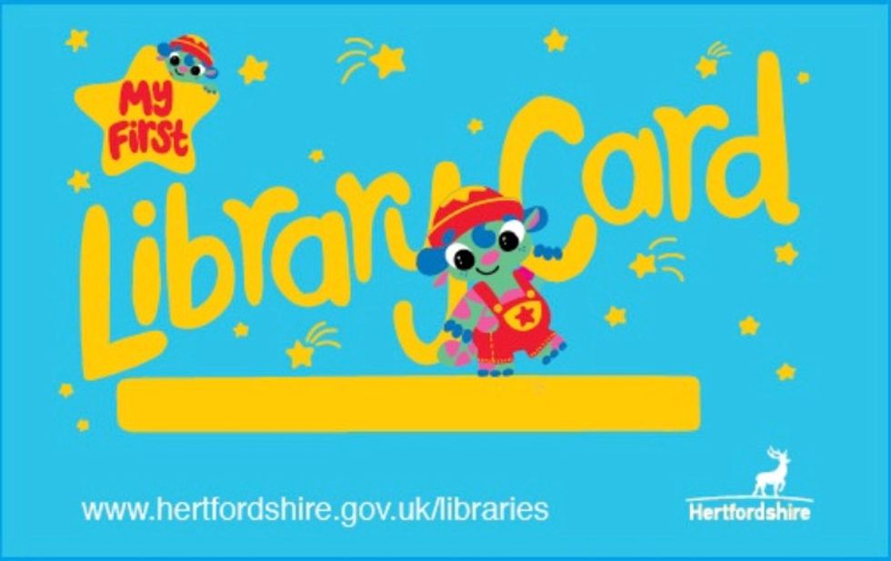A library card featuring Tala the alien