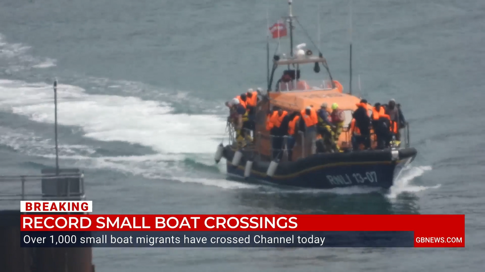 A lifeboat carrying migrants arrives into Dover Harbour