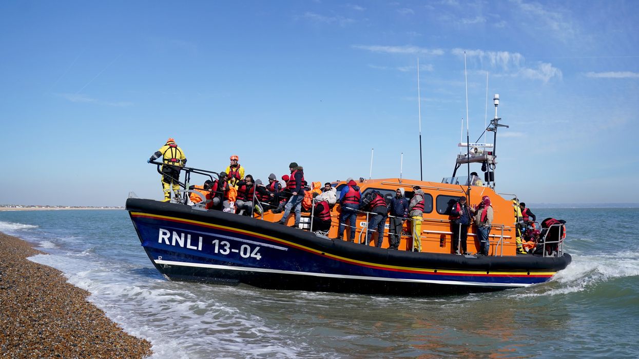 A lifeboat carrying migrants arrives on British shores