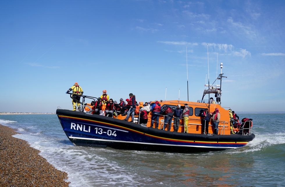 A lifeboat carrying migrants arrives on British shores