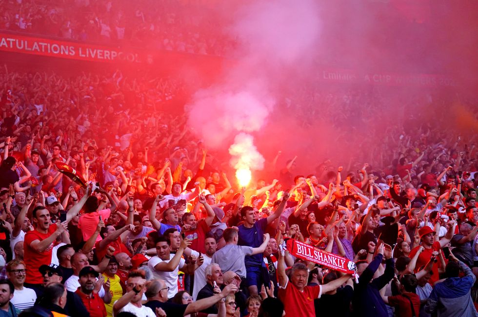 A Liverpool fan sets off a flare during the Emirates FA Cup final at Wembley Stadium, London. Picture date: Saturday May 14, 2022.