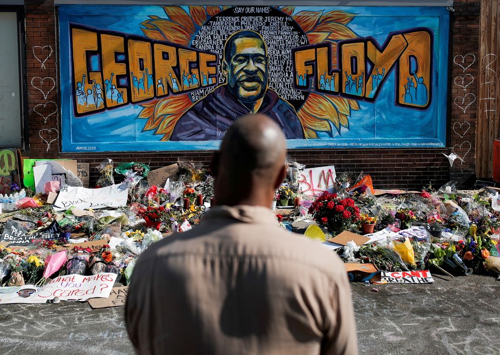 A local resident stands in front of a makeshift memorial honouring George Floyd, at the spot where he was taken into custody, in Minneapolis, Minnesota, U.S., June 1, 2020.