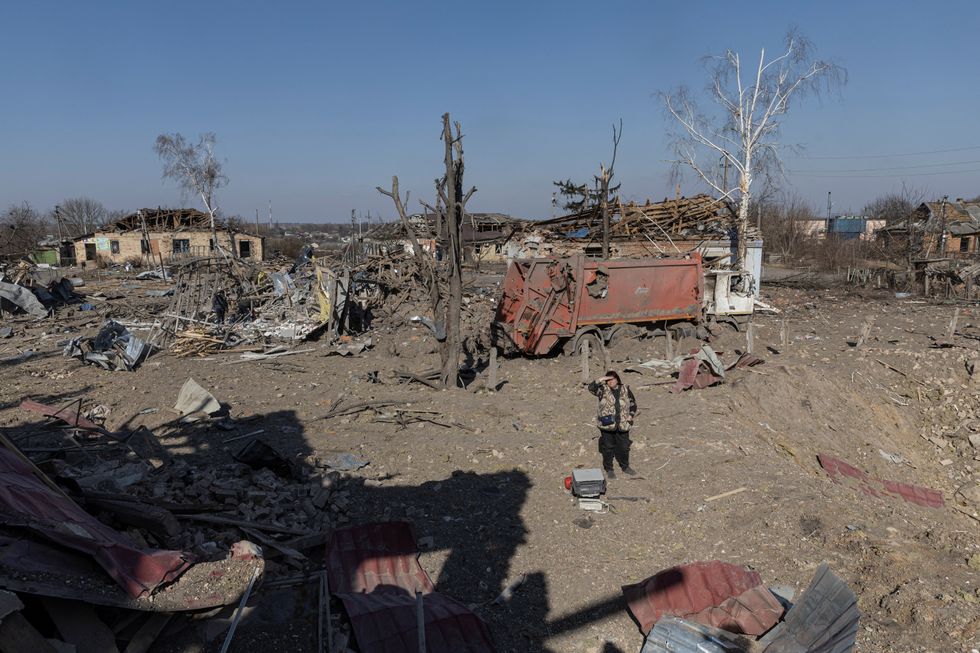 A local woman looks on at the cultural centre destroyed in shelling earlier this month, as Russia's invasion of Ukraine continues, in the village of Byshiv outside Kyiv, Ukraine, March 24, 2022. REUTERS/Marko Djurica