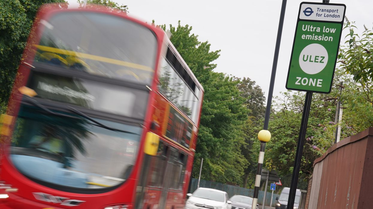 A London bus passes an information sign for the Ultra Low Emission Zone (Ulez) in London
