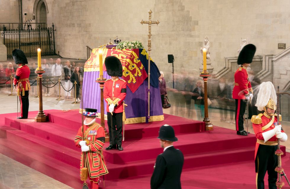 A long exposure photograph showing members of the public as they file past the coffin of Queen Elizabeth II, draped in the Royal Standard with the Imperial State Crown and the Sovereign's orb and sceptre, lying in state on the catafalque in Westminster Hall, at the Palace of Westminster, London, ahead of her funeral on Monday. Picture date: Thursday September 15, 2022. Danny Lawson/Pool via REUTERS