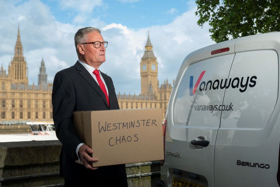 A lookalike of Sir Keir Starmer outside the Houses of Parliament with moving boxes