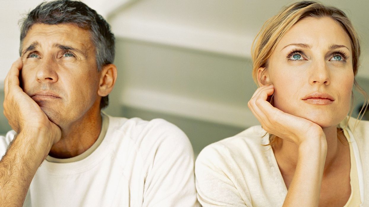 A man and woman looking pensive next to each other