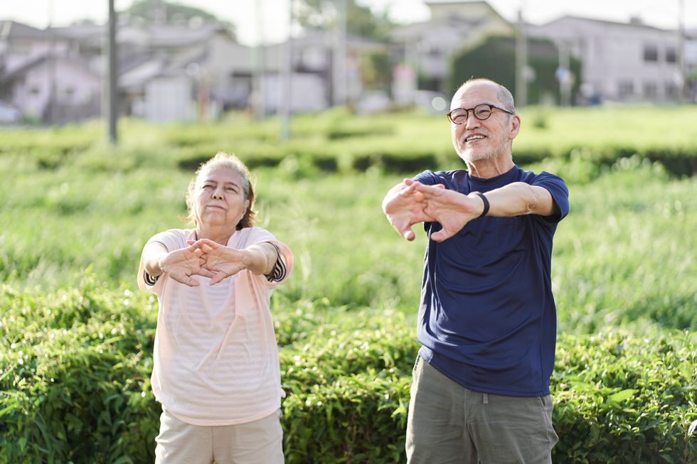 A man and woman stretching outside