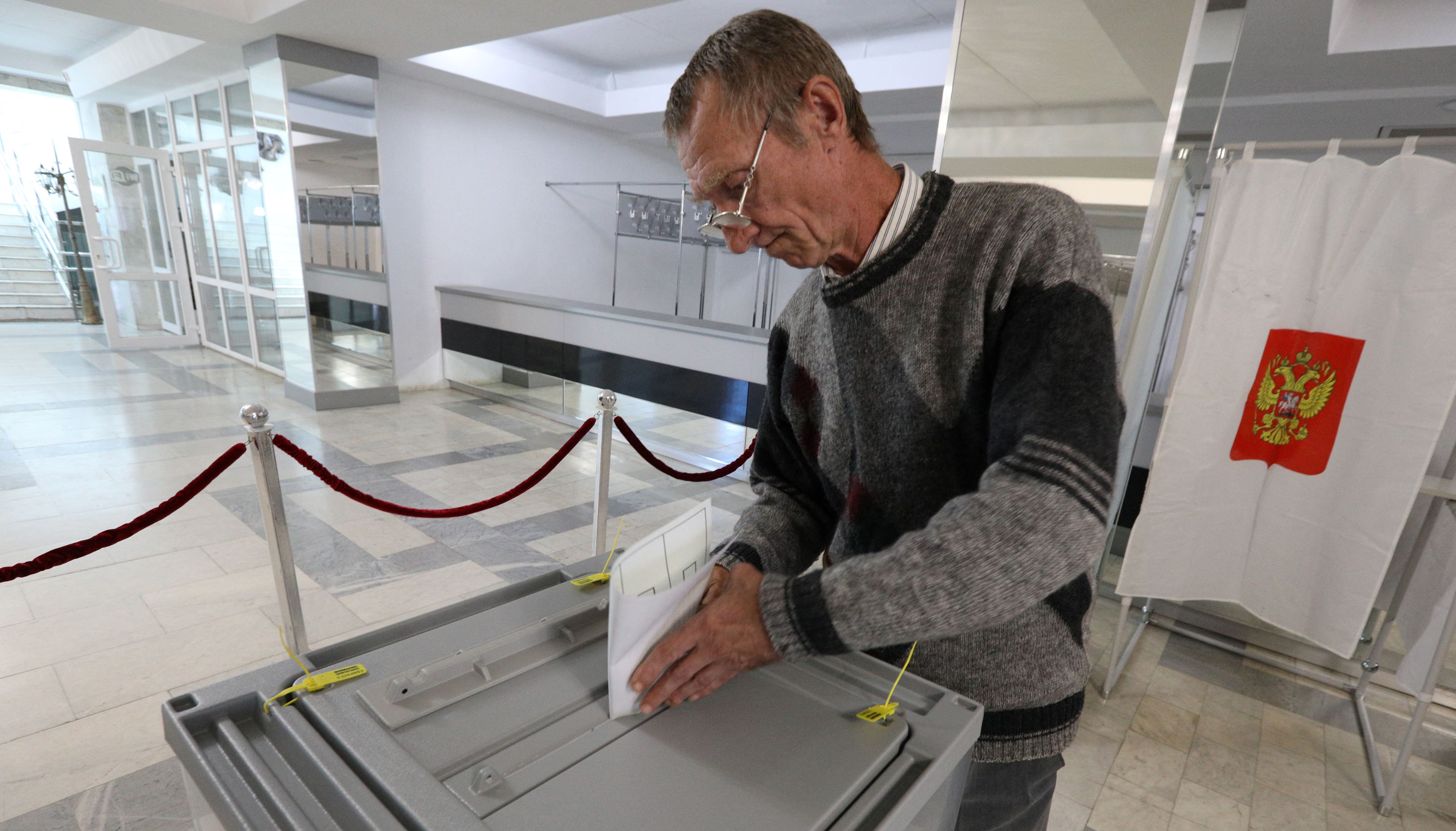 A man casts his ballot during the first day of a referendum on the joining of Russian-controlled regions of Ukraine to Russia