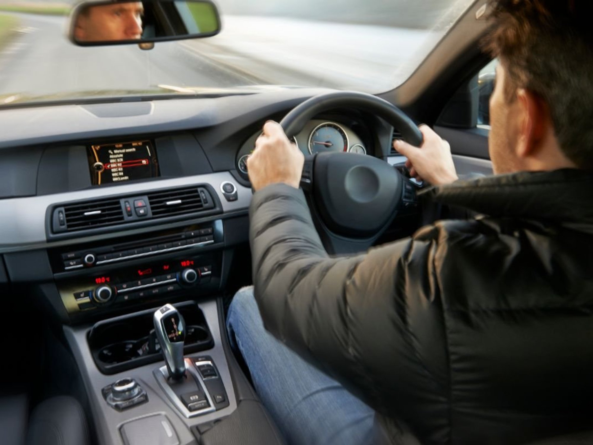 A man driving an automatic car