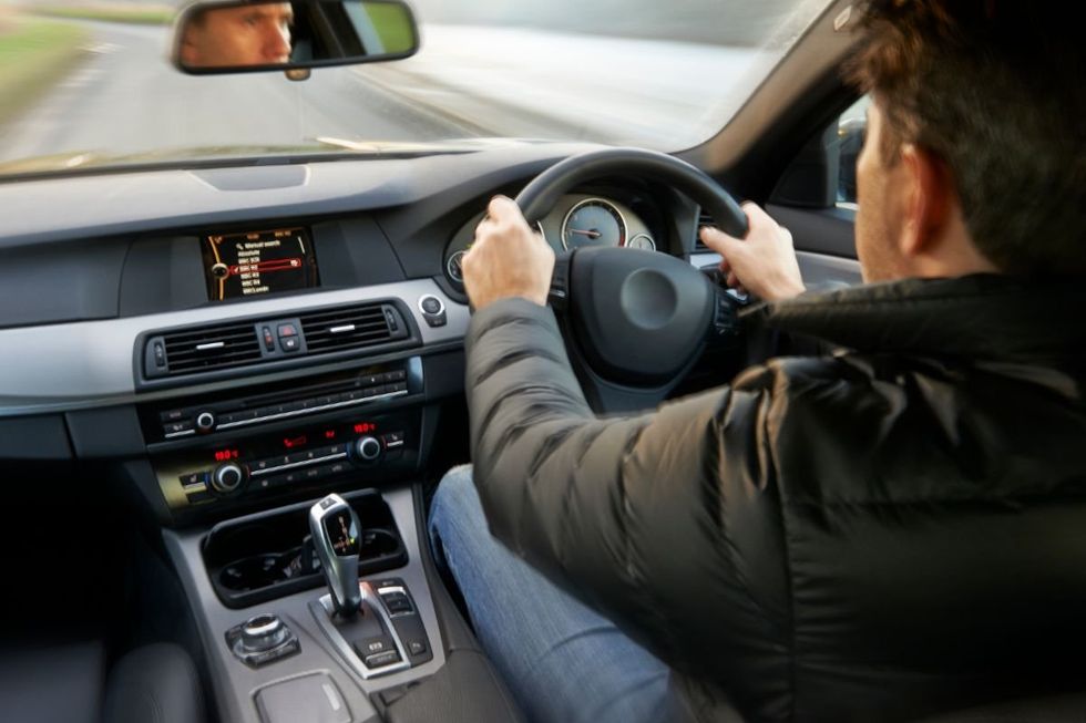 A man driving an automatic car