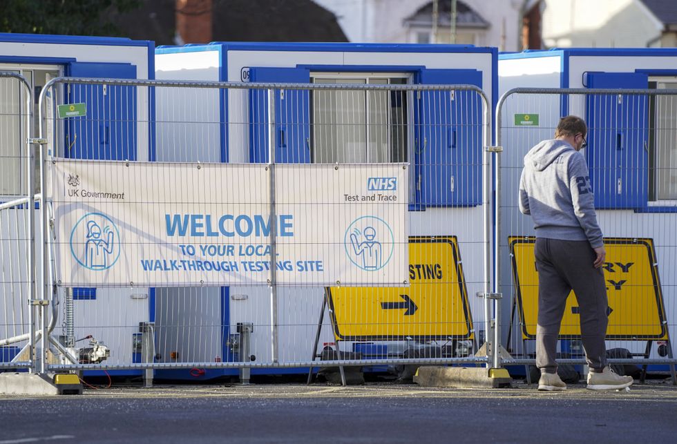 A man enters a walk-in NHS testing centre in Camberley, Surrey. The UK Health Security Agency have said people in England without coronavirus symptoms who have a positive lateral flow test will no longer need a confirmatory PCR test from January 11. Picture date: Wednesday January 5, 2022.