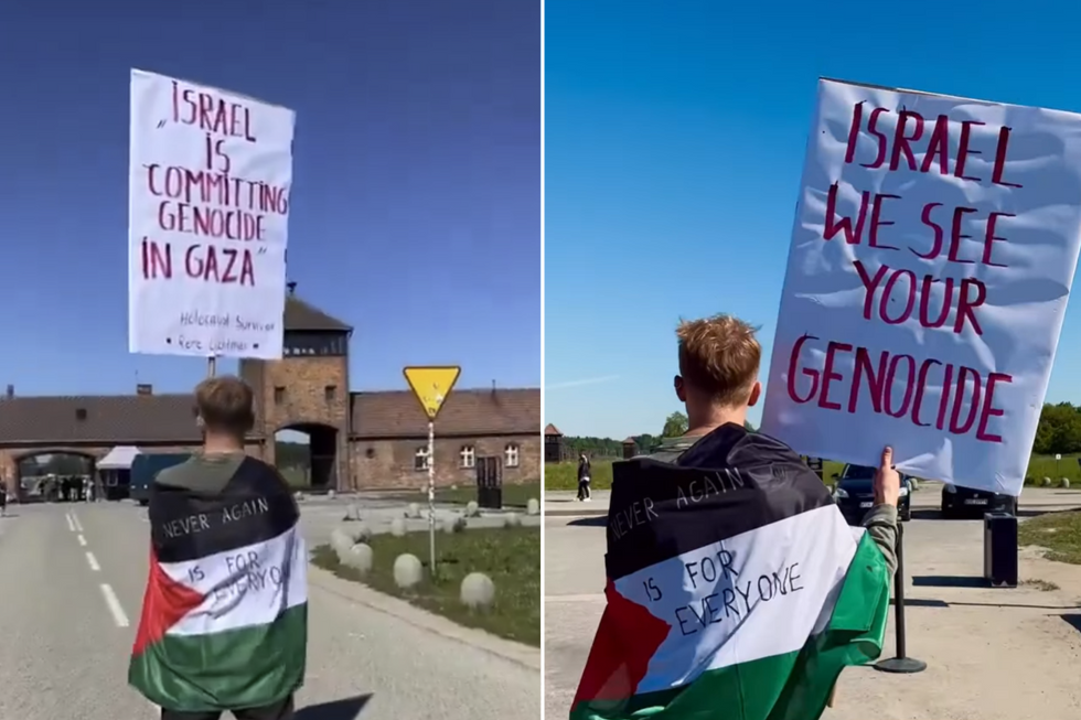 A man holding a sign at Auschwitz