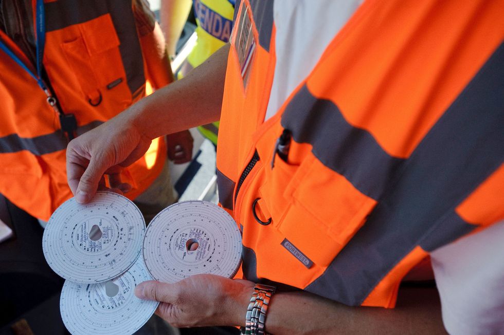 A man holding a tachograph