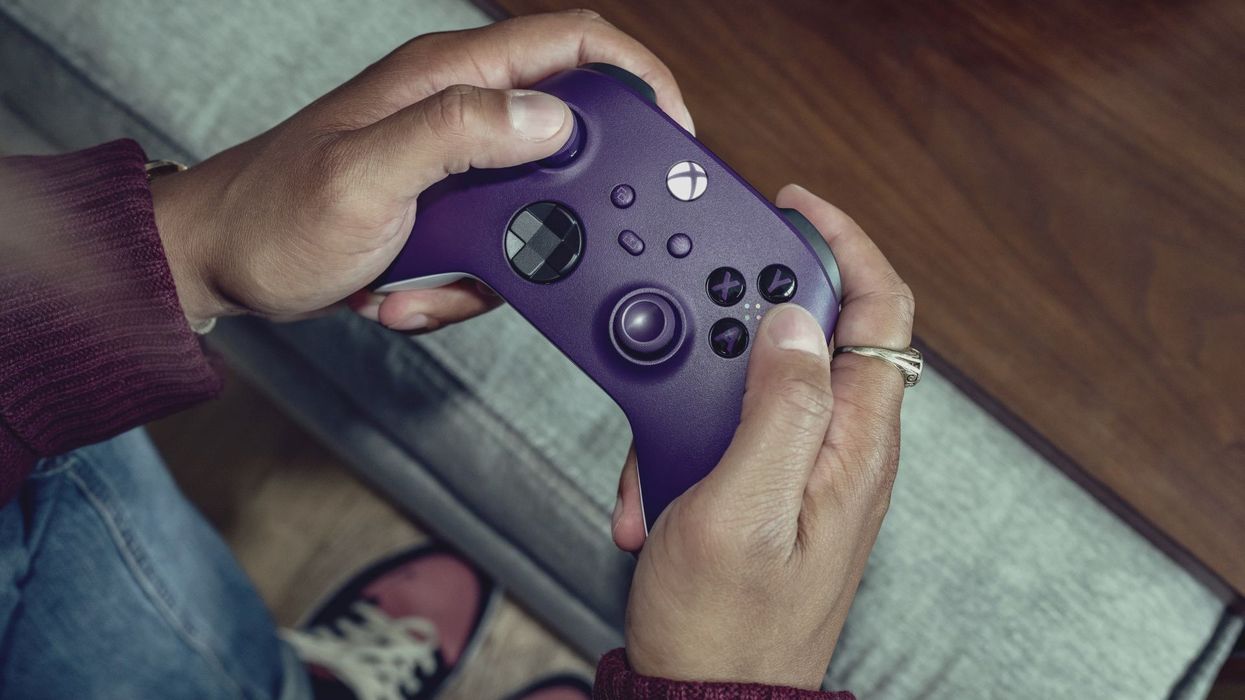 a man holds an astral purple xbox wireless controller