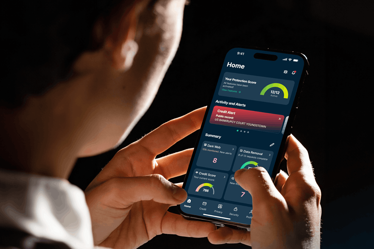 a man holds an iPhone in both hands with ExpressVPN shown on-screen