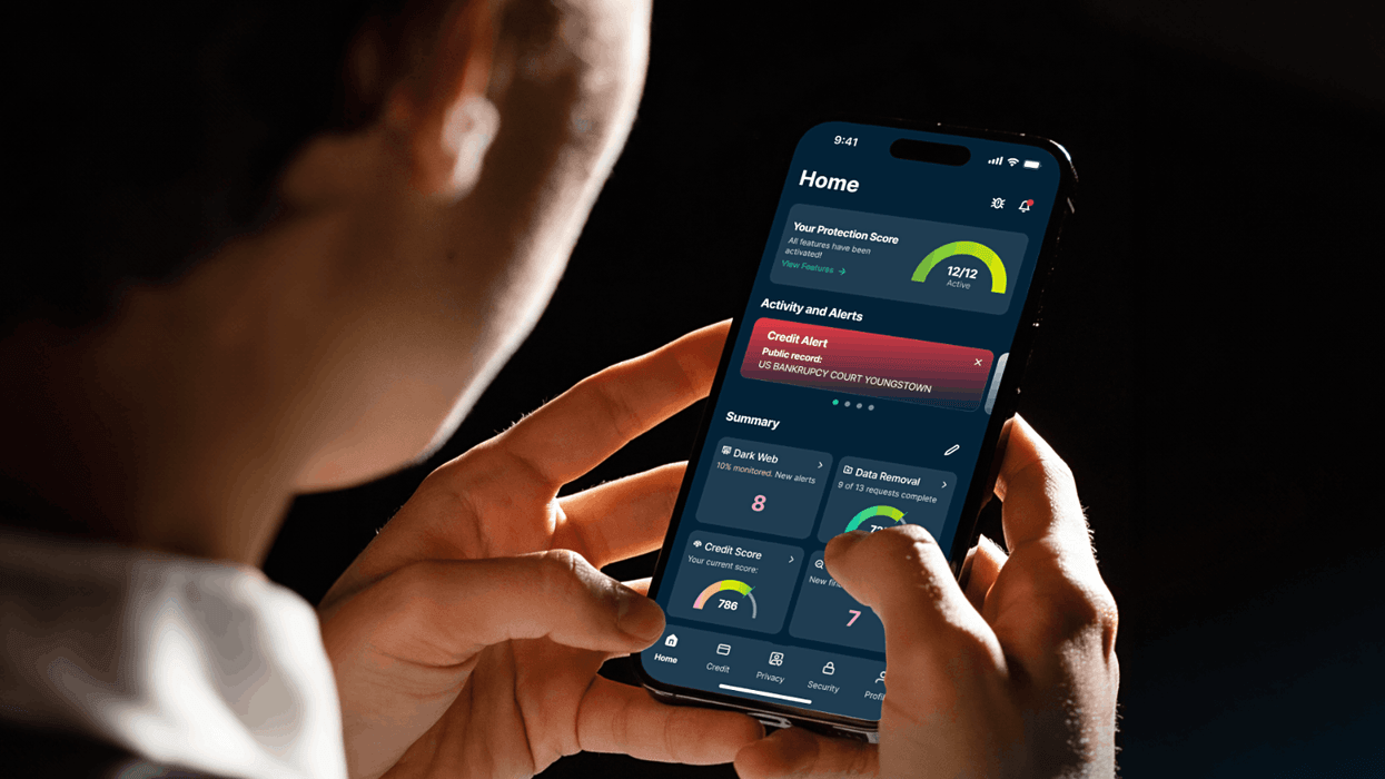 a man holds an iPhone in both hands with ExpressVPN shown on-screen