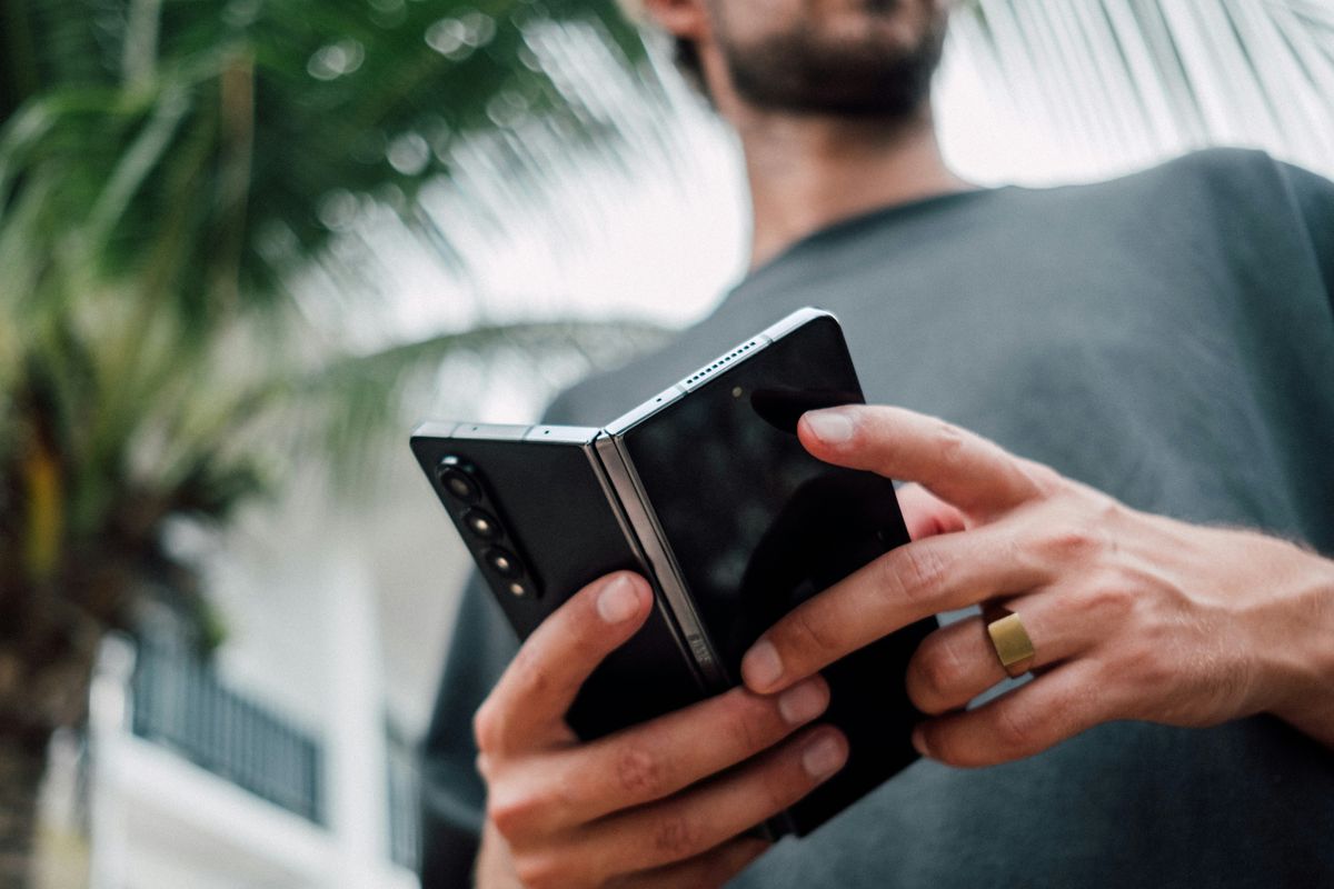a man holds the samsung galaxy z fold, one of the first folding smartphones to hit the market 