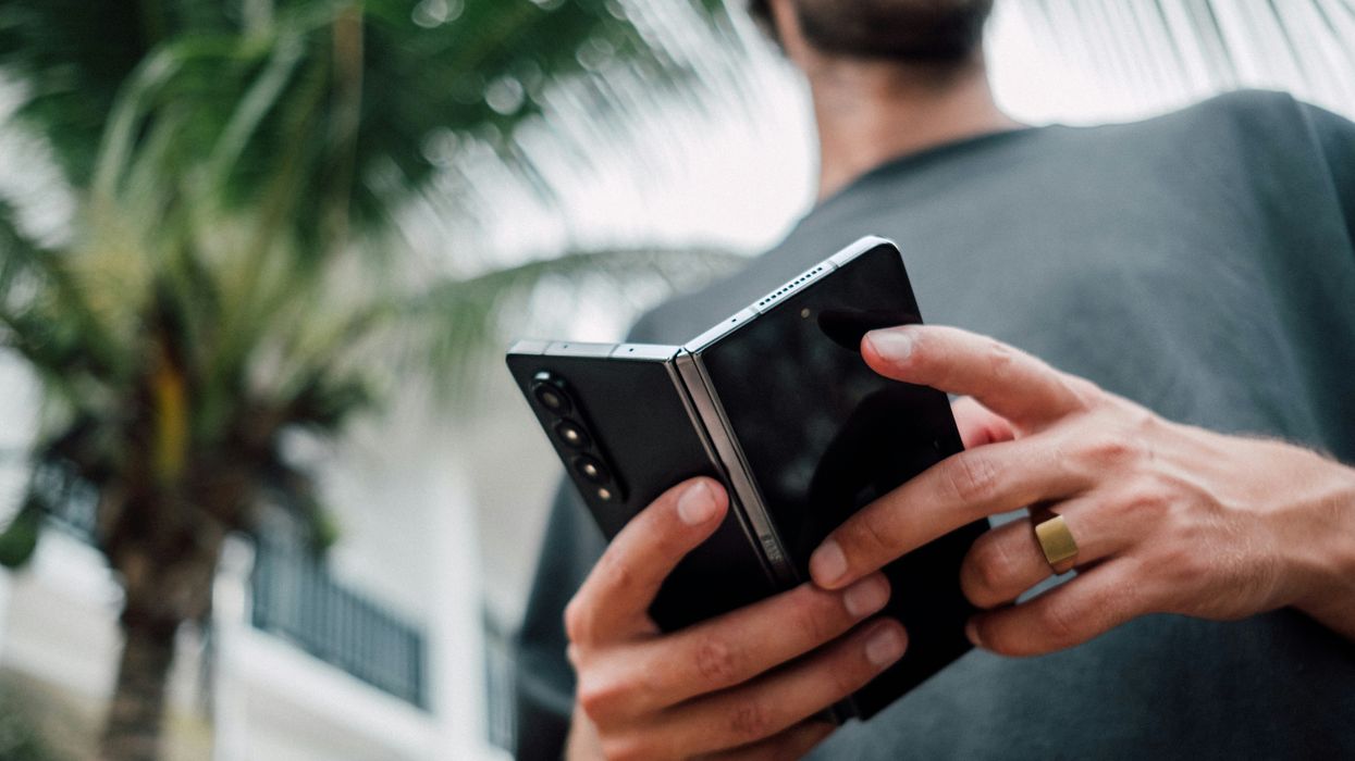 a man holds the samsung galaxy z fold, one of the first folding smartphones to hit the market