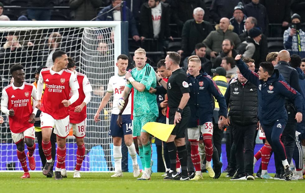 A man in the crowd appeared to kick the Arsenal goalkeeper