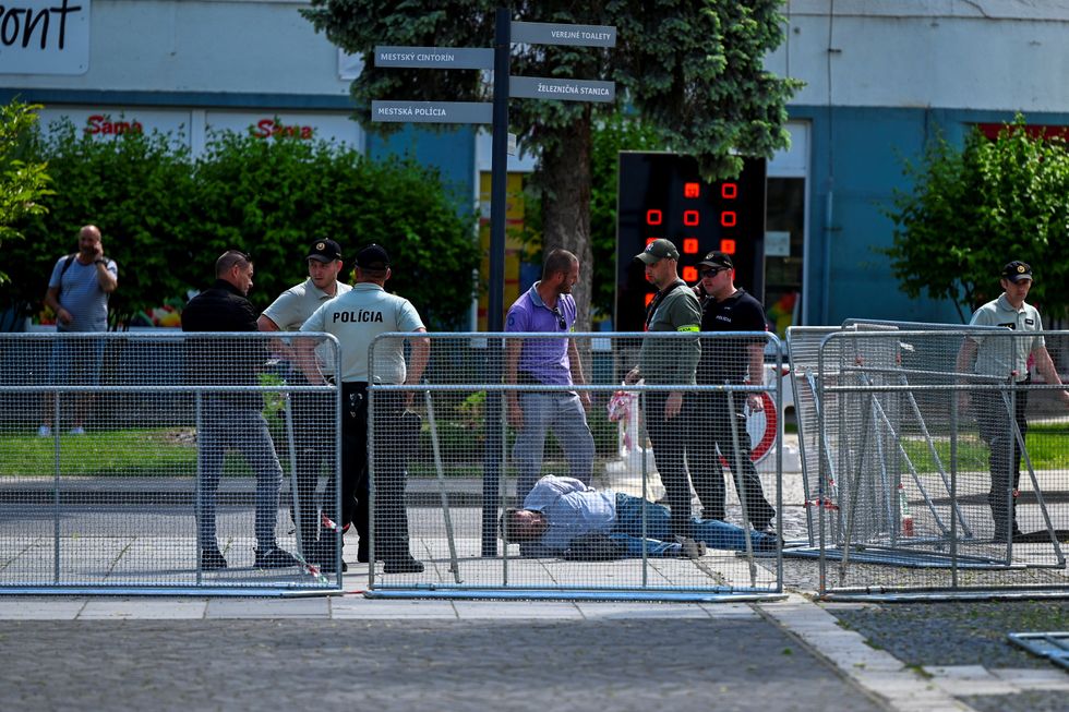 A man is detained outside the government meeting