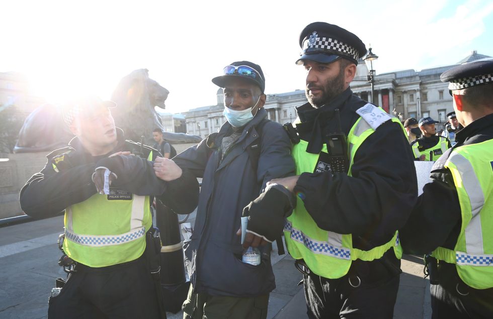 A man is led away by police during Black Lives Matter rally in Trafalgar Square, London.