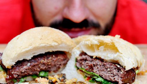 A man looks at dry roasted locusts, salt and vinegar crickets, plain roasted meal worms and sweet chilli pigeon burgers at Rentokil's Pop-up Pestaurant at One New Change, central London.