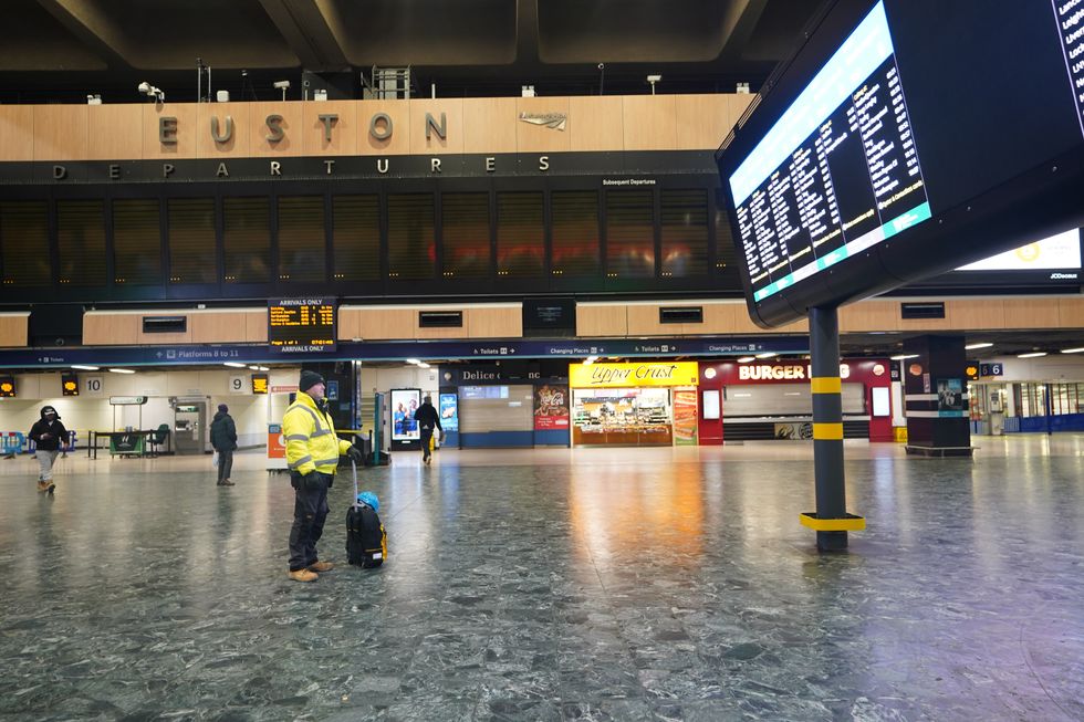A man looks at the departures board at Euston train station in London during a strike by members of the Rail, Maritime and Transport union (RMT) in a long-running dispute over jobs and pensions. Picture date: Wednesday December 14, 2022.