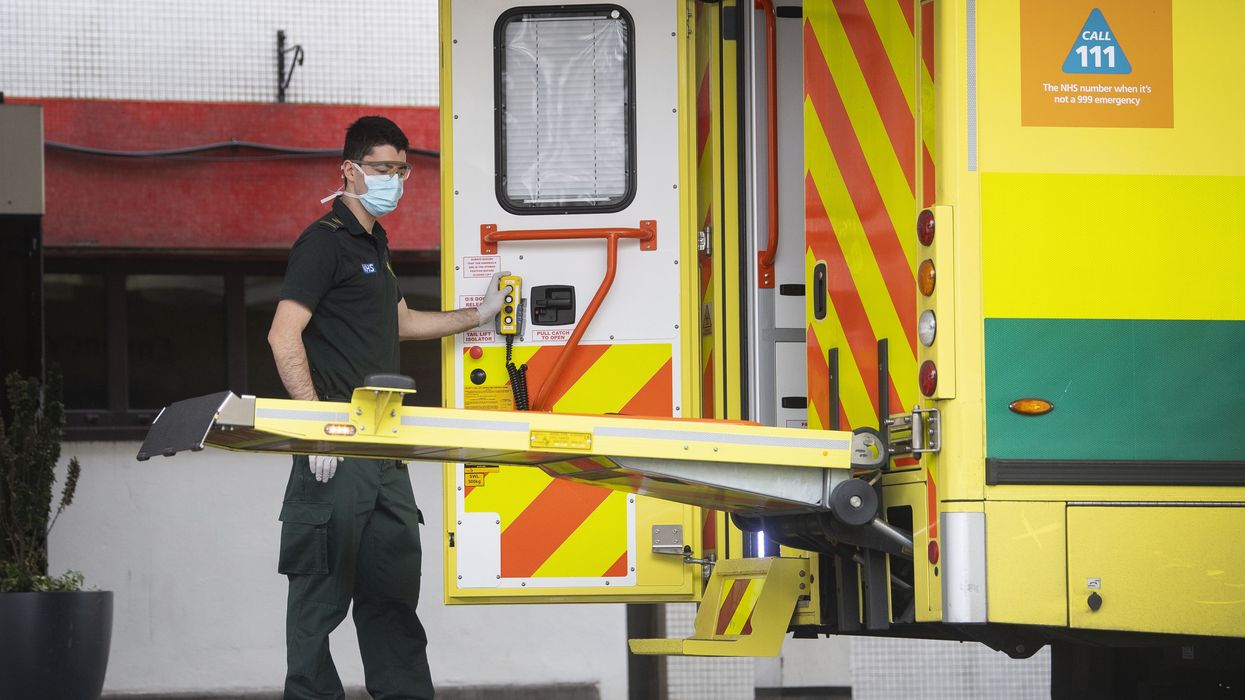 A man operates an ambulance wearing PPE during the pandemic