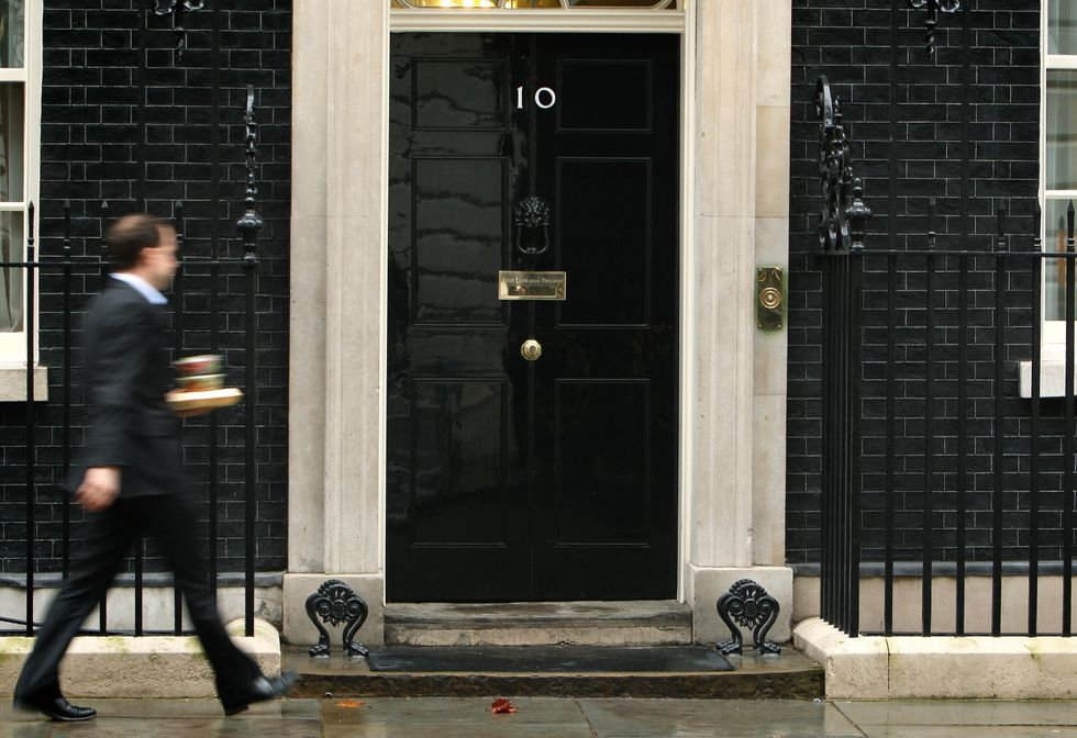 A man outside 10 Downing Street in London, as Conservative leader David Cameron and his Liberal Democrat counterpart Nick Clegg both called on 10 Downing Street today to look into allegations of bullying of staff.
