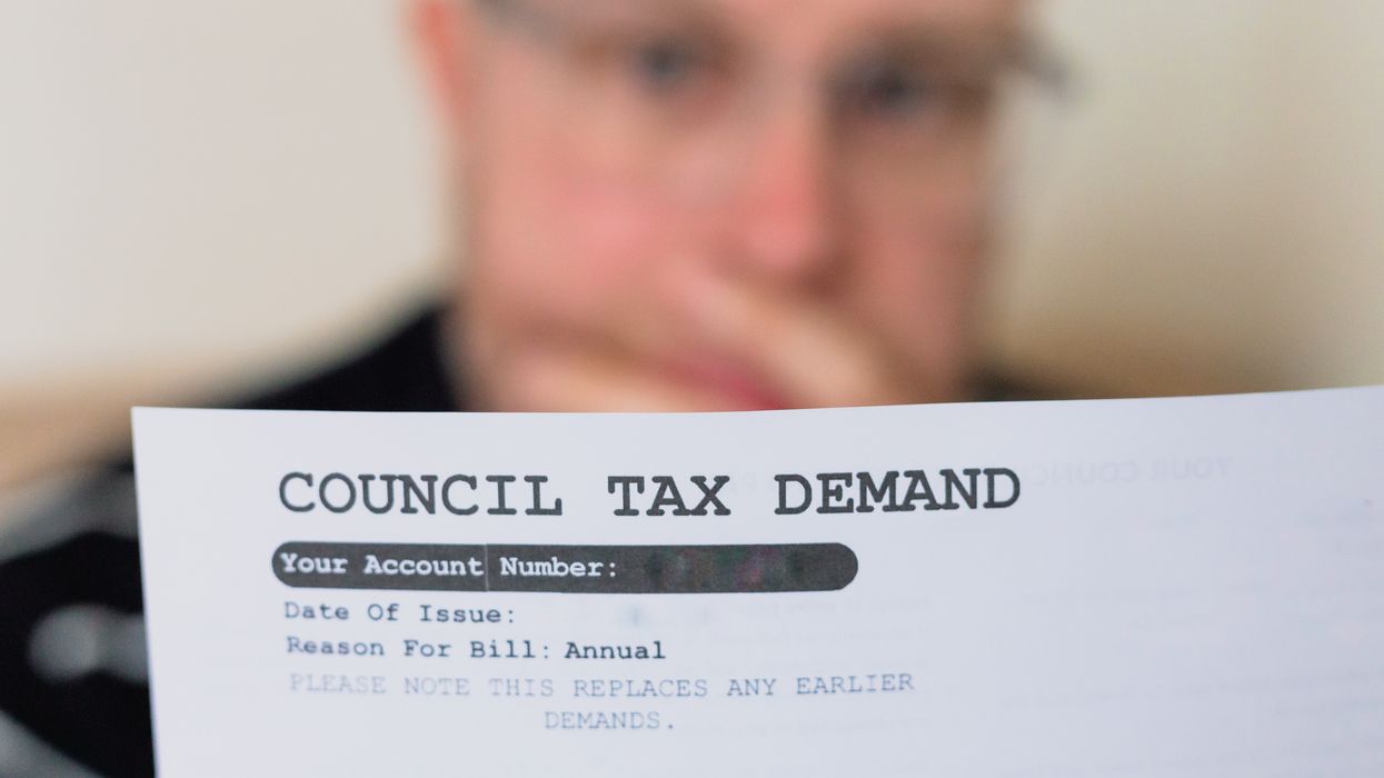 A man reading his council tax bill