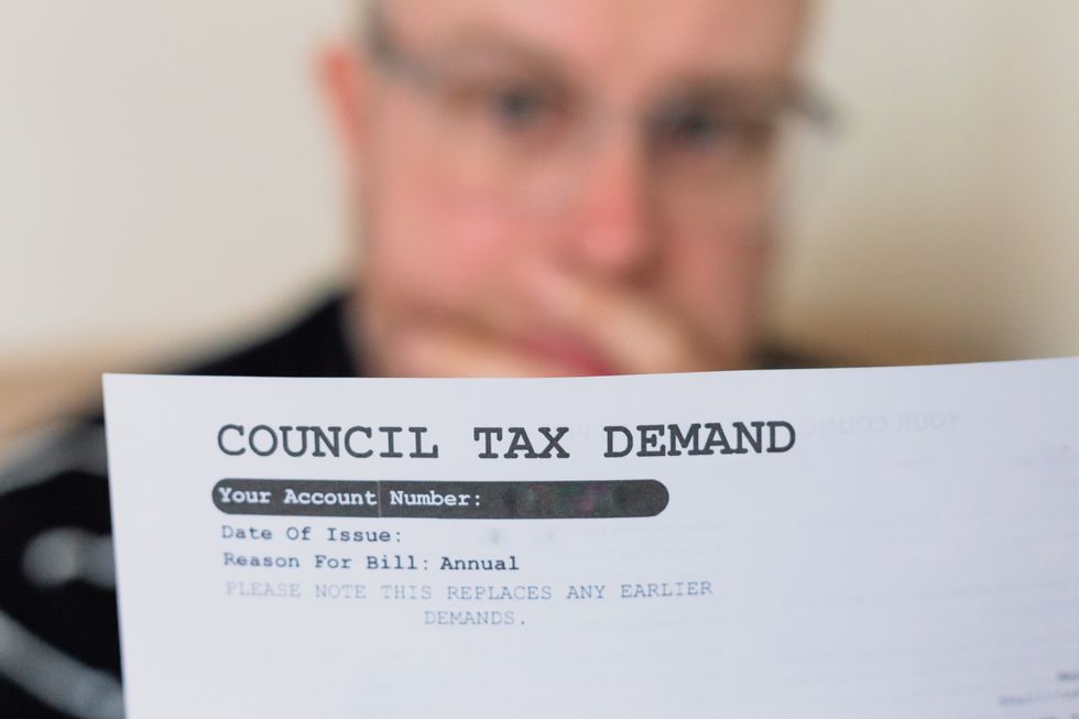 A man reading his council tax bill