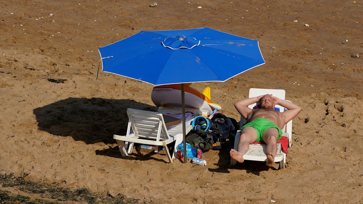 A man relaxes on the beach in Broadstairs, Kent