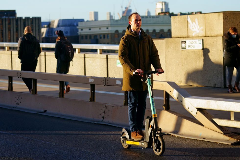 A man riding an e-scooter