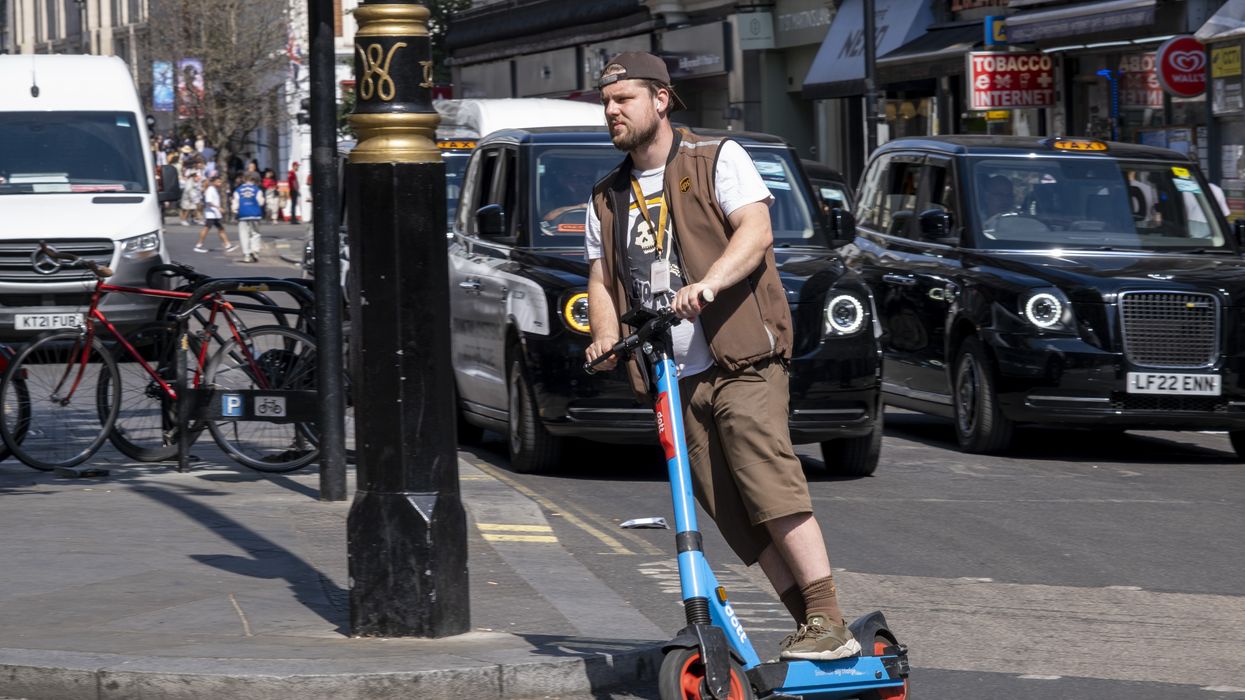A man riding an e-scooter