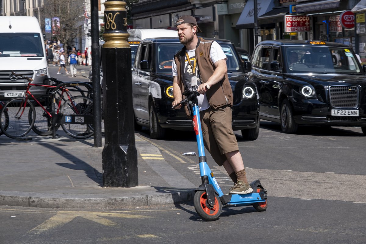 A man riding an e-scooter