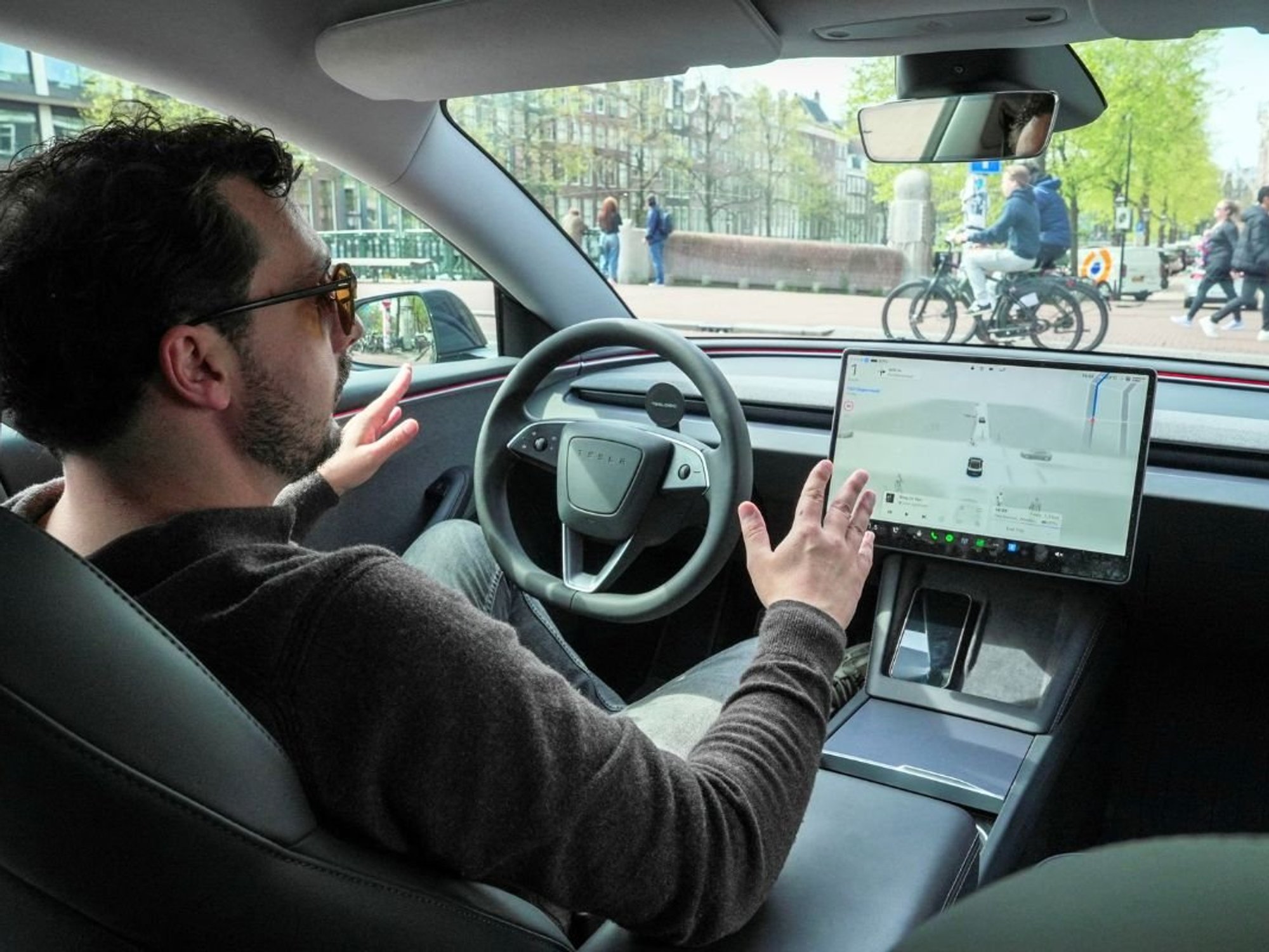 A man riding in a self-driving vehicle