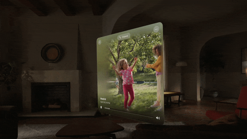a man sits with the Vision Pro and watches a Spatial Video clip