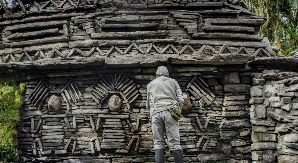 A man stands in front of the \u200bArchaeological structures in Gran Pataj\u00e9n