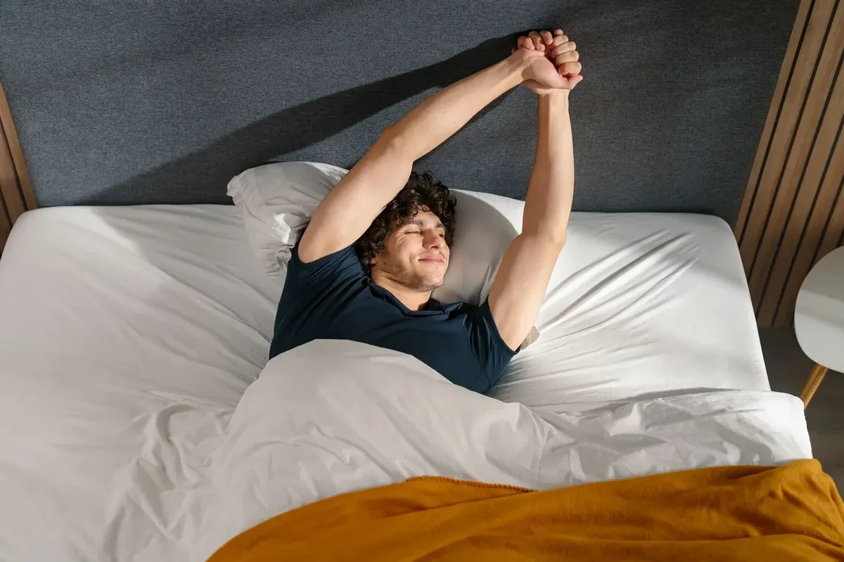 a man stretches on an emma mattress 