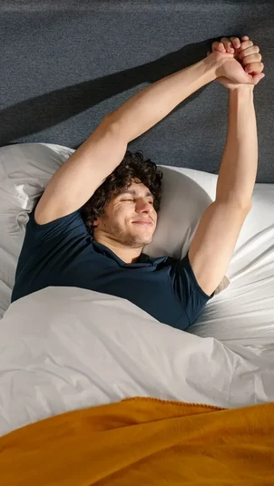 a man stretches on an emma mattress