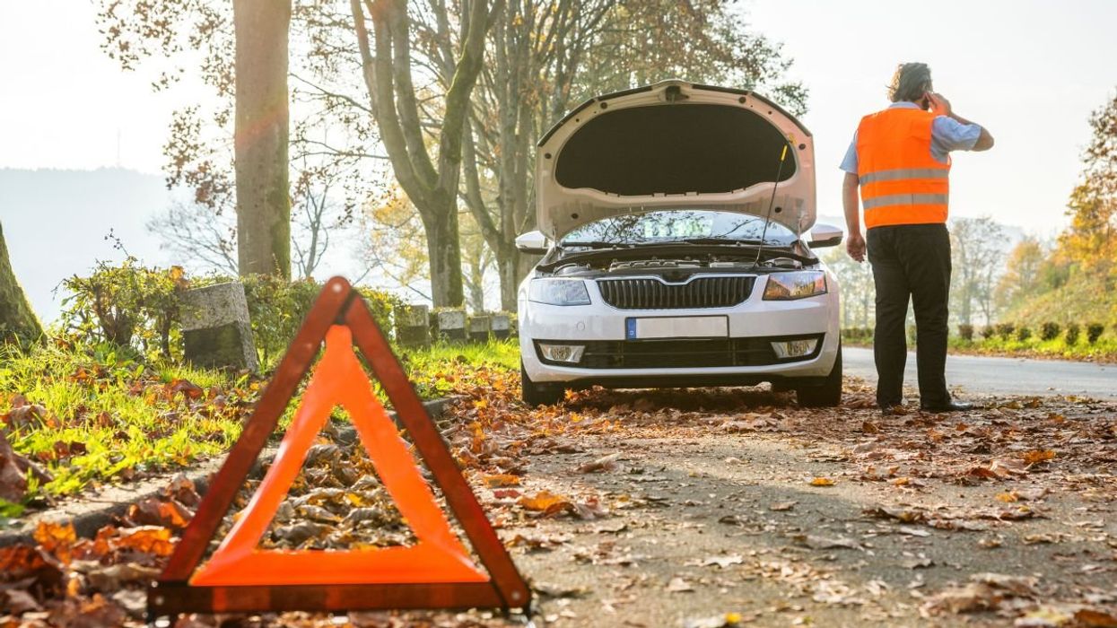 A man waiting for his vehicle to be repaired after breaking down