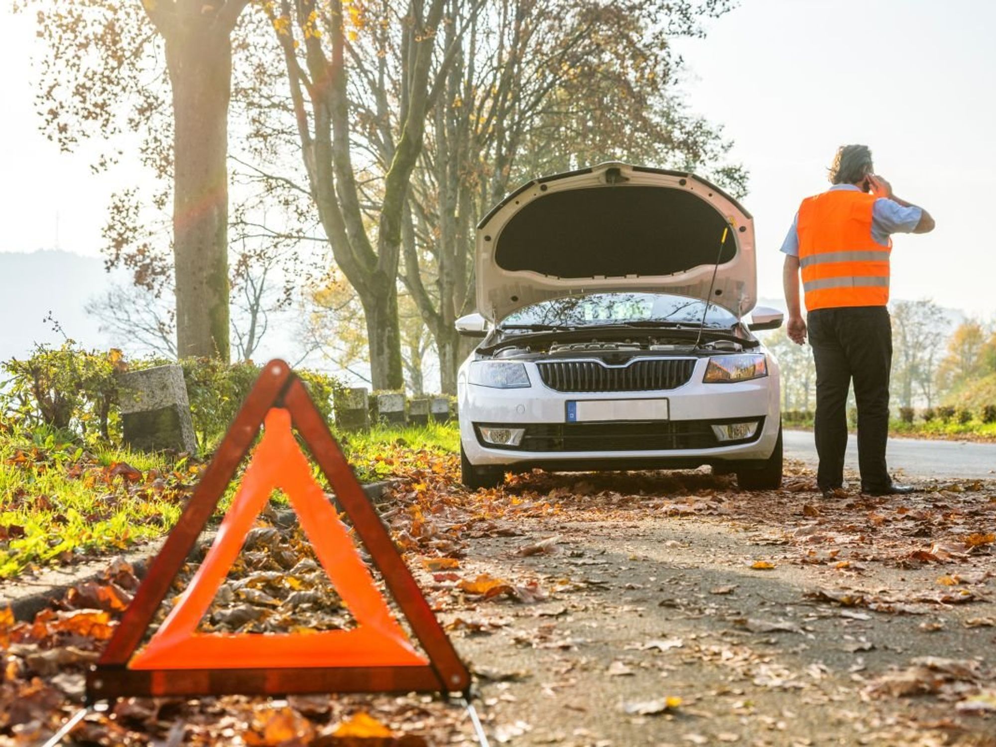 A man waiting for his vehicle to be repaired after breaking down