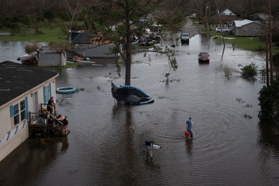 A man walks back to his home after sharing fuel with his neighbours, to use for their generator, in the aftermath of Hurricane Ida in Cut Off, Louisiana.