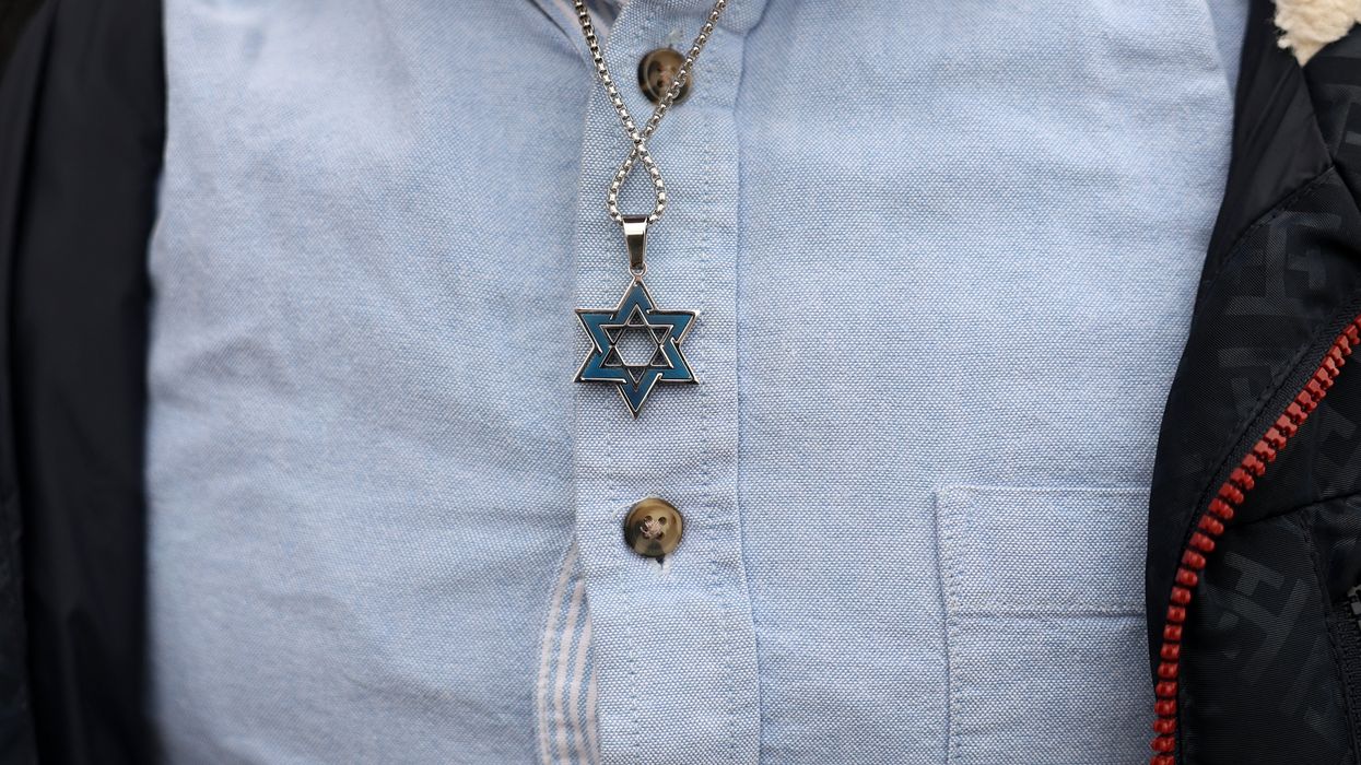 A man wearing a Star of David necklace