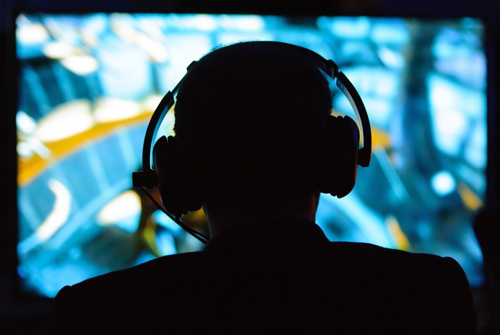 A man wearing headphones plays on a games console at a preview event for Star Trek: the Video Game, at the Science Museum, in central Lodnon.