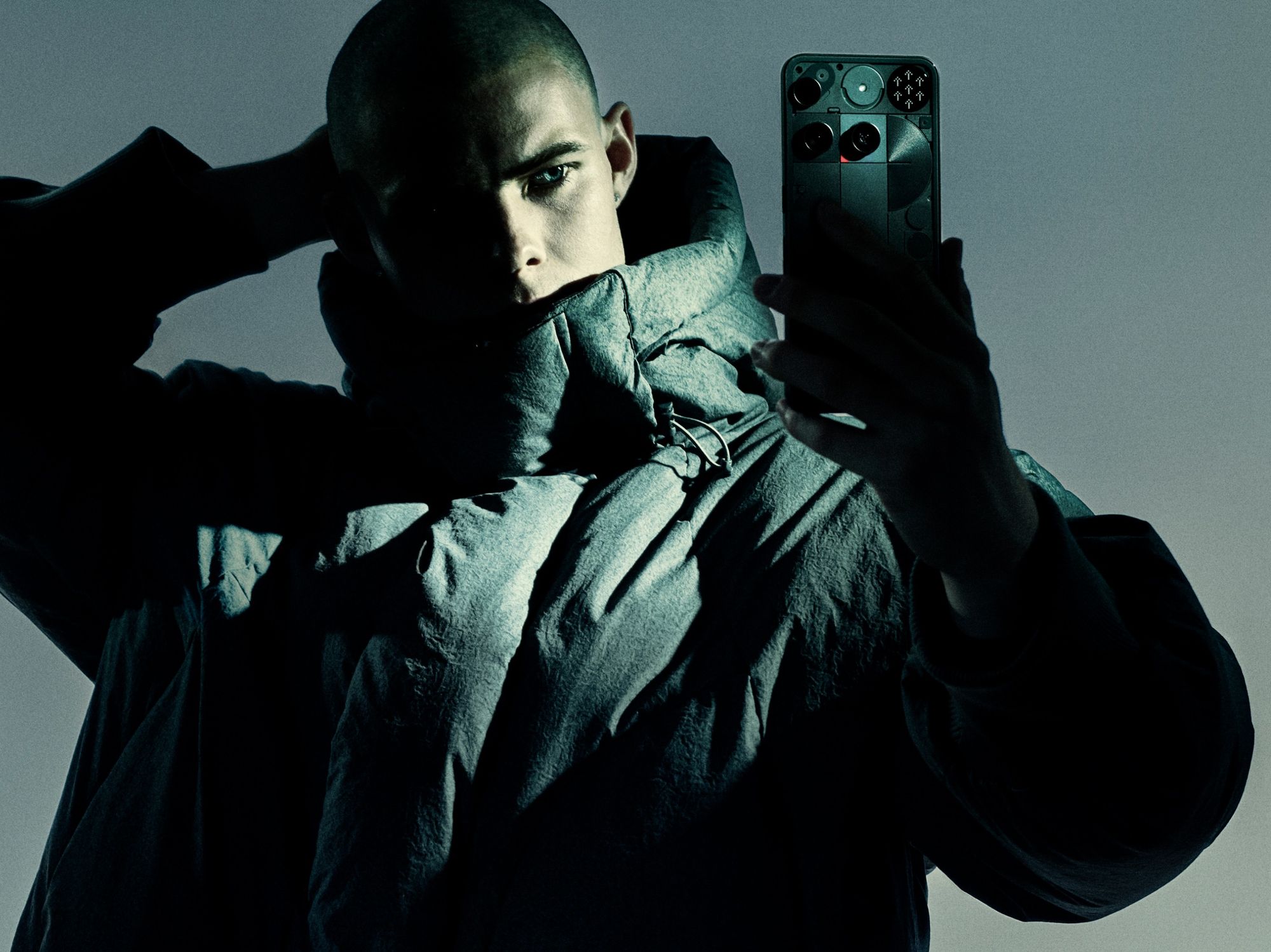 a mand holds the nothing phone 3 with the red dot for recording video shown