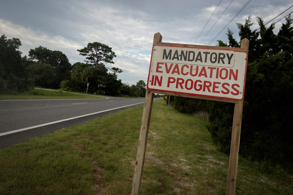 A mandatory evacuation sign is seen ahead of the arrival of Hurricane Idalia, in Cedar Key, Florida
