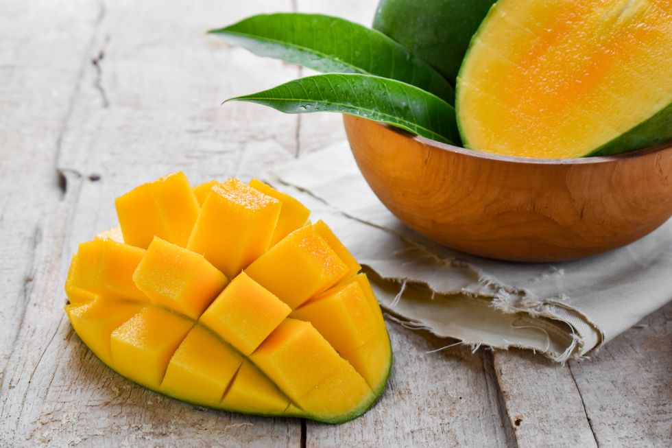 A mango, halved and cut open