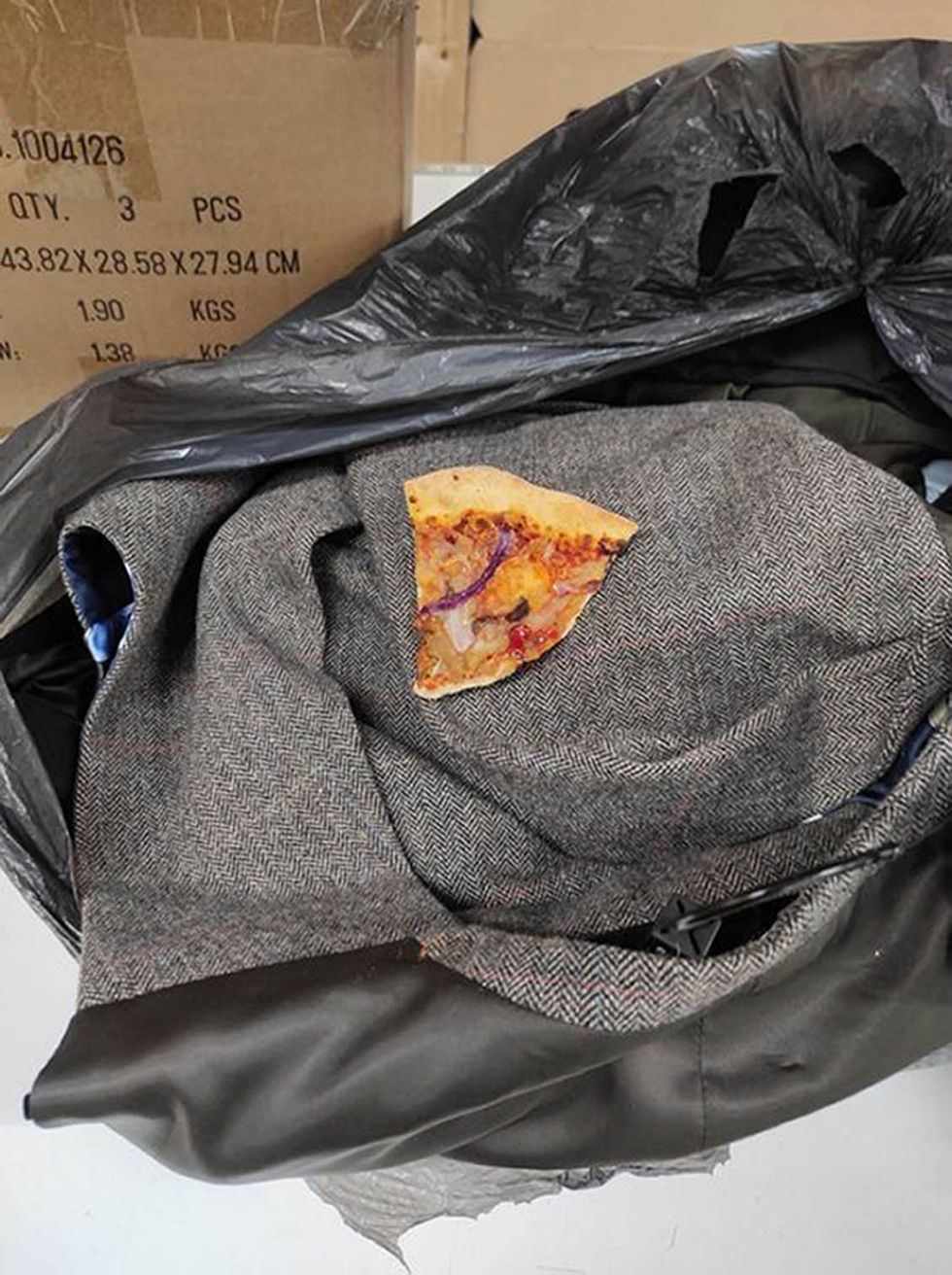A mans coat with a slice of pizza inside that was handed into Barnardo's in Catterick , one of the strangest items left by contributors at its stores.